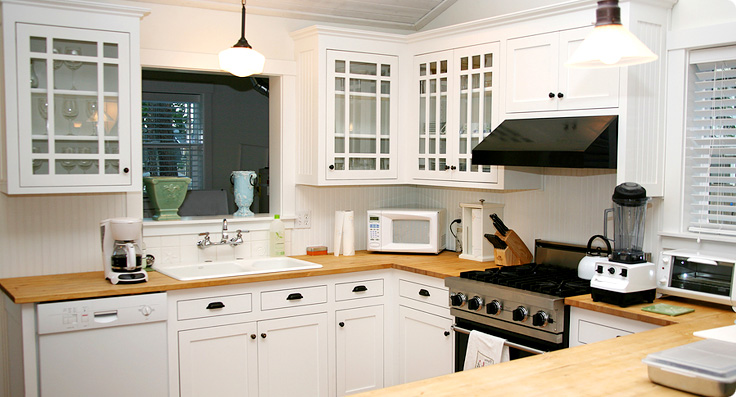 Clean white kitchen with oven and hob
